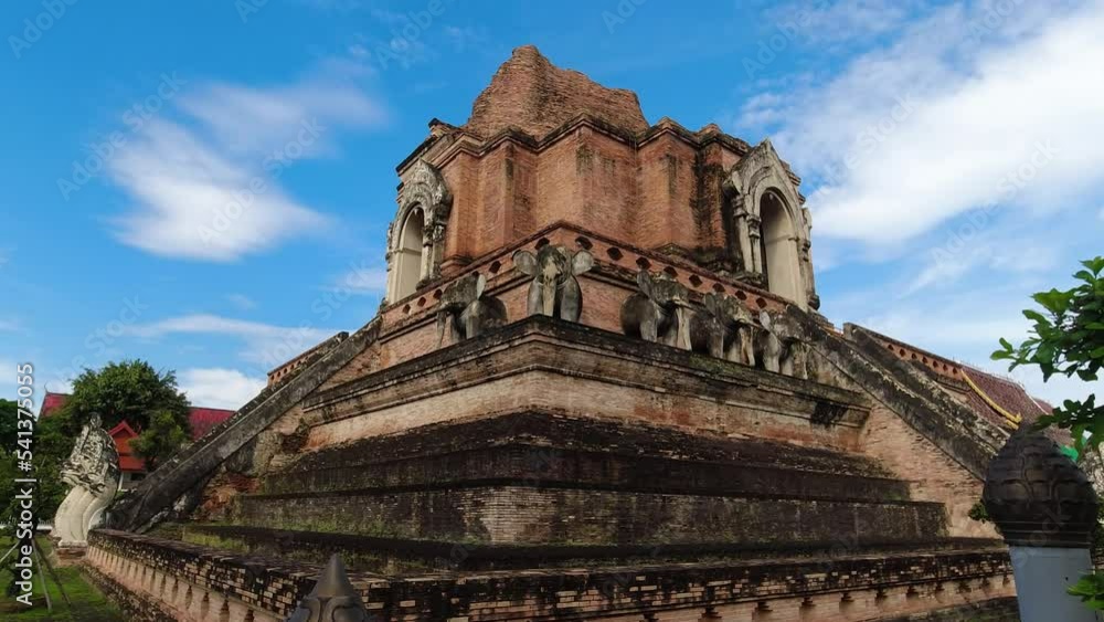 Wide handheld view of side of Wat Chedi Luang in Chiang Mai