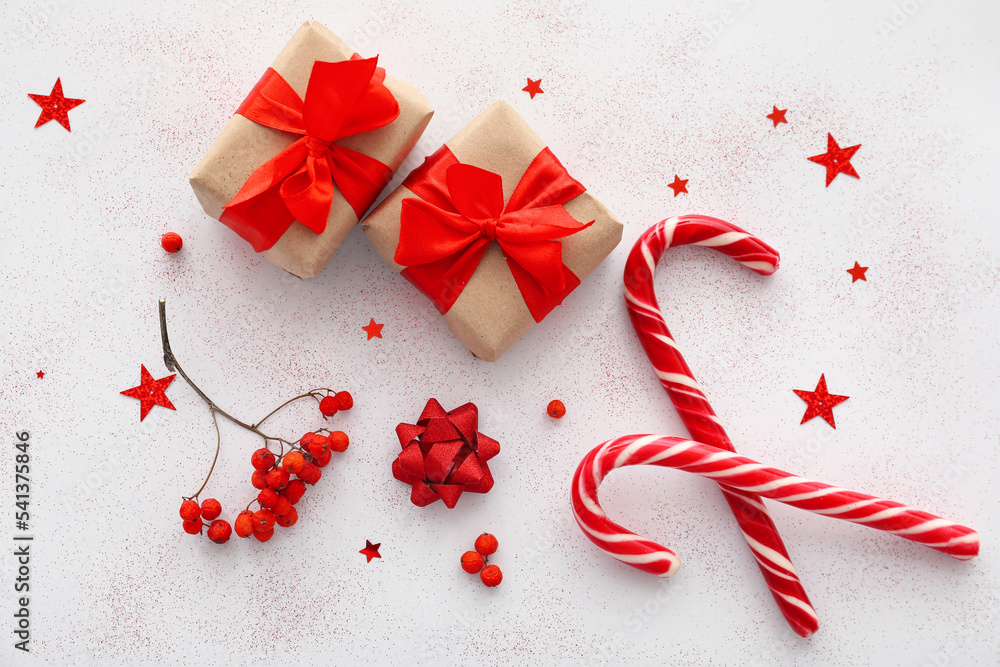 Composition with Christmas gifts, candy canes and rowan berries on