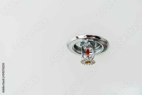Fire Sprinkler detector mounted on roof in home or apartment. Safety and conflagration security concept