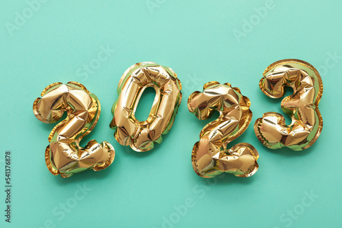 Figure 2023 made of balloons on green background