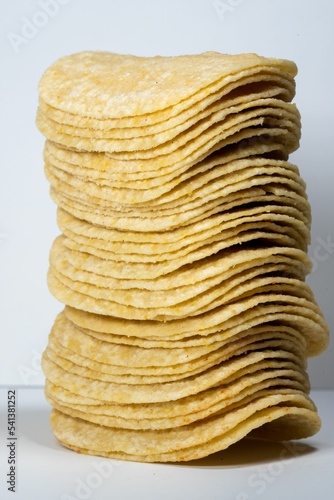 Vertical shot of the stack potatoes chips isolated on gray background