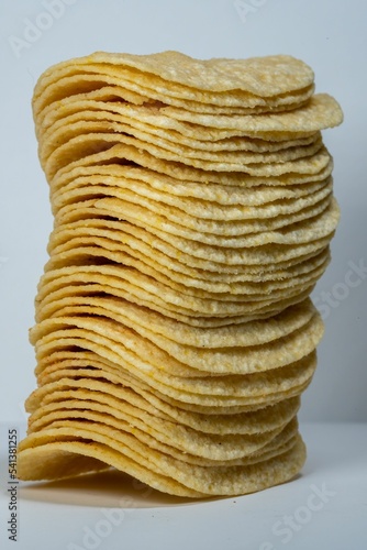Vertical shot of the stack potatoes chips isolated on gray background