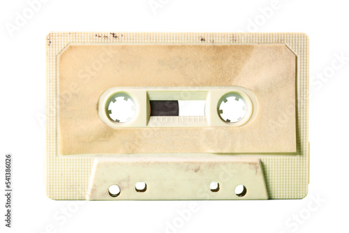 Isolated old vintage cassette tape from the 1980s (obsolete music technology). Vivid colors: dirty cream plastic body, desert sand label. 