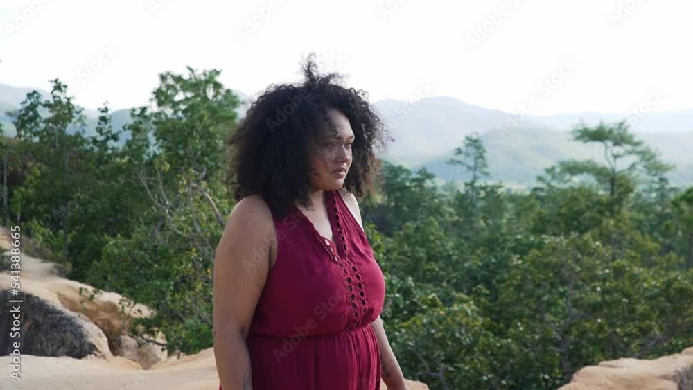 Black curly woman scared of hights focussing and smiling at the camera. Black curly woman scared of hights focussing and smiling at the camera.