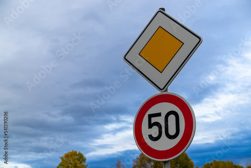 road sign with 50 kmh and right of way, Germany in autumn photo