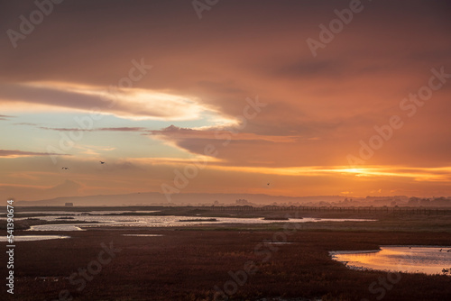 Moody stormy colourful sunset skies over Rye Harbour nature reserve on the East Sussex coast south east England © SuxxesPhoto