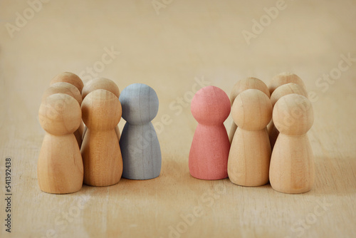 Two groups of wooden pawns with male and female leader facing each other - Concept of competition and male vs female leadership