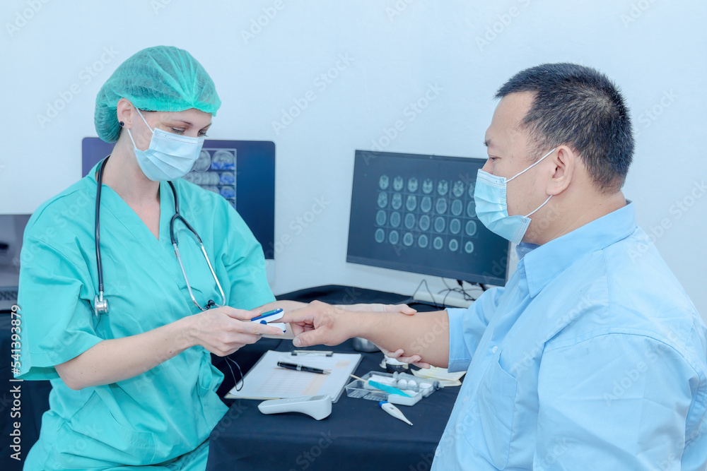 Doctor checking oxygenation with fingertip pulse oximeter. Saturation blood of oxygen. Measuring the patient's blood saturation with an oximeter Doctor checking oxygenation with fingertip pulse oximeter. Saturation blood of oxygen. Measuring the patient's blood saturation with an oximeter