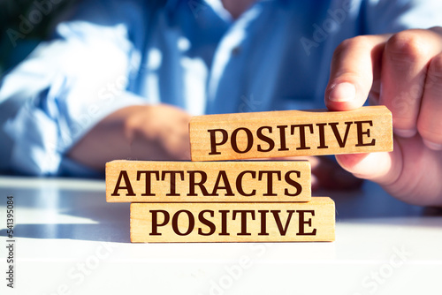Wooden blocks with words 'Positive Attracts Positive'. photo