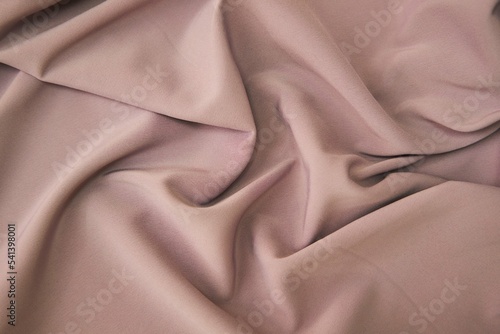 The texture of the fabric is cream-colored. Textile industry for the creation of clothing.