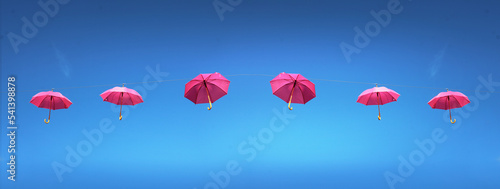 Octobre rose, parapluie rose dans le ciel bleu, concept bannière, avec espace vide pour du texte photo