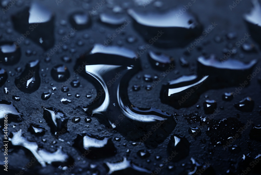 Wet water drops on black surface Wet water drops on black surface