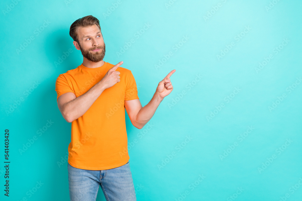 Photo of nice brown hairdo guy look promo wear orange t-shirt isolated on teal color backgroiund Photo of nice brown hairdo guy look promo wear orange t-shirt isolated on teal color backgroiund