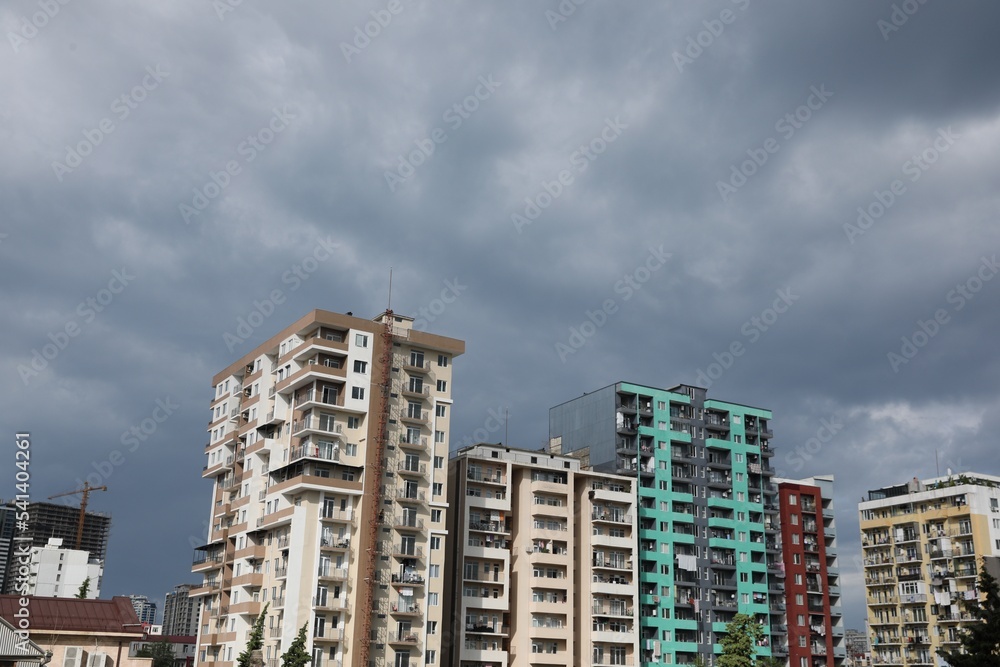 Beautiful view of multi storey apartment buildings under gloomy sky