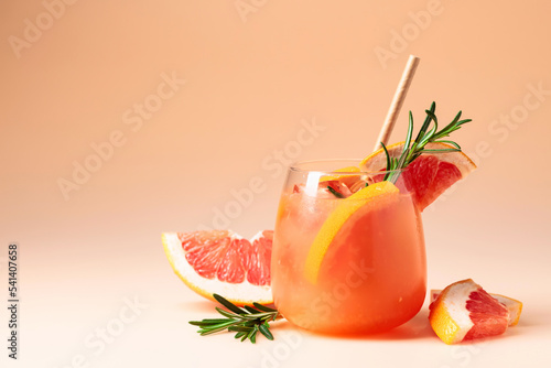 Summer cocktail with grapefruit, rosemary, and ice.