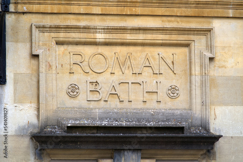 Lettering at famous roman bath at City of Bath on a cloudy summer day. Photo taken August 2nd, 2022, Bath, United Kingdom. photo