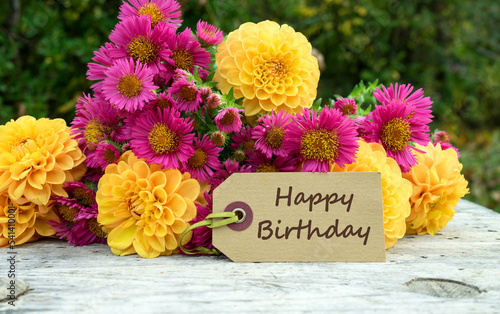 Birthday card with a bouquet of autumn flowers and the text in English: Happy Birthday