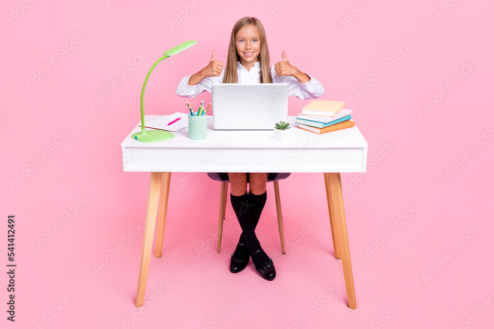 Full length photo of clever satisfied schoolgirl wear school uniform showing thumbs up good job isolated on pink color background Full length photo of clever satisfied schoolgirl wear school uniform showing thumbs up good job isolated on pink color background