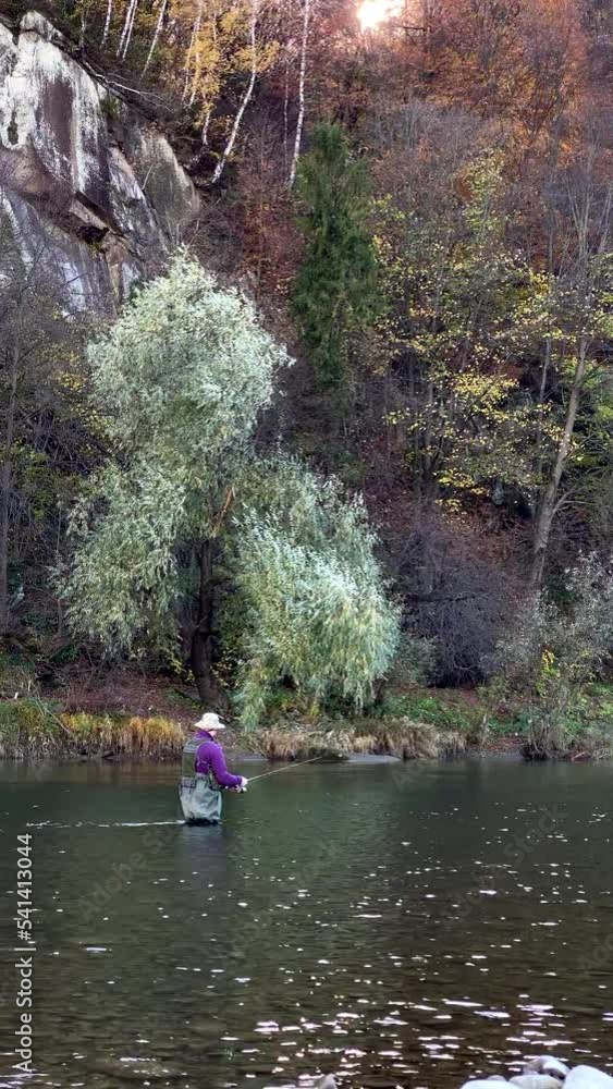 fisherman fishing standing in mountain river autumn season fisherman fishing standing in mountain river autumn season