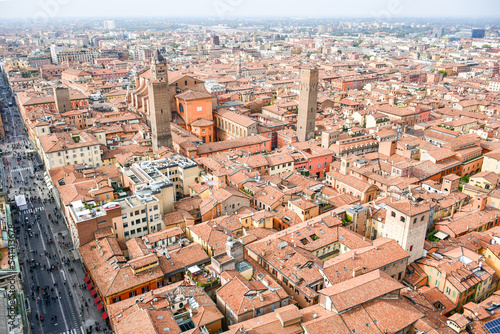 Aerial Cityscape view from the tower Asinelli on Bologna old town center with Maggiore square in Italy.Colorful sky over the historical city center with car traffic and old buildings