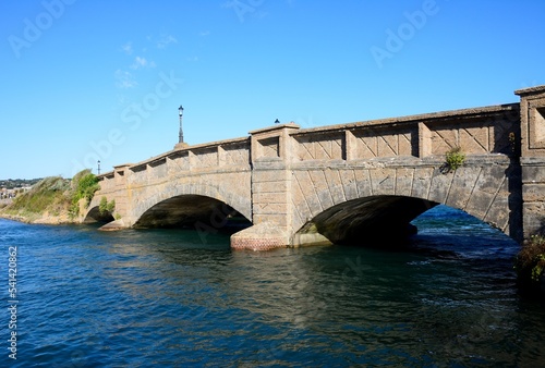 Stone footbridge across the River Axe, Axmouth, Devon, UK/