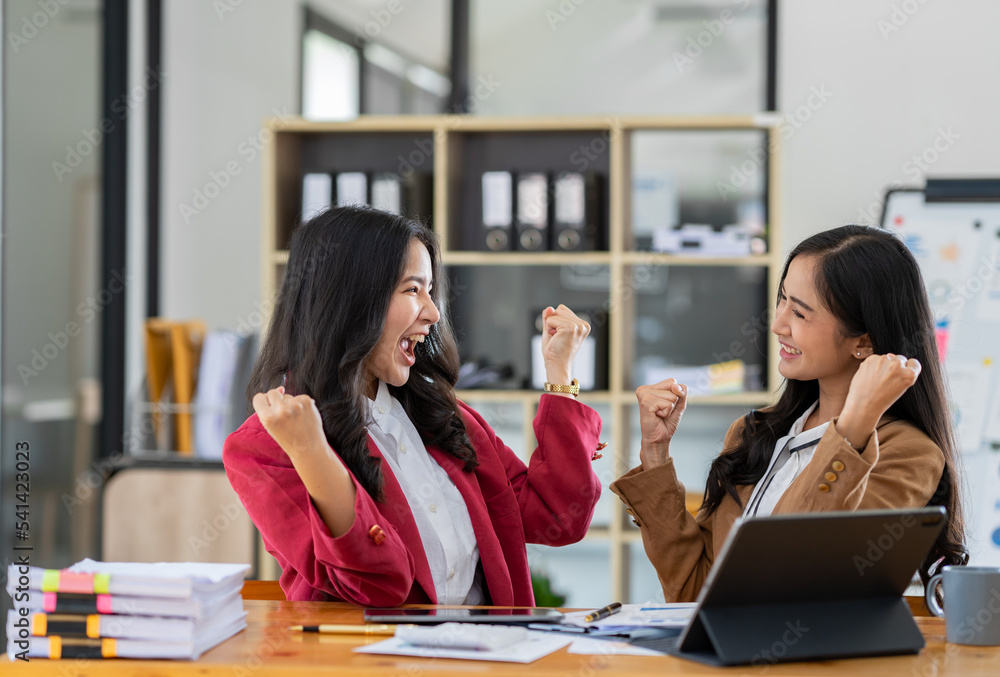 Two young businesswomen are delighted to be successful in online business. and had a huge income. Two young businesswomen are delighted to be successful in online business. and had a huge income.