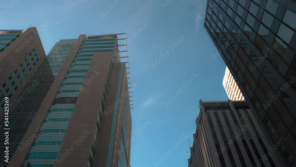Office highrise buildings in the city center. Slow motion, low angle view, dolly shot. Office highrise buildings in the city center. Slow motion, low angle view, dolly shot.