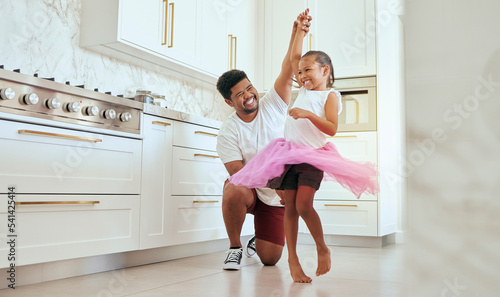 Dad, girl and ballet dance of a child in a home kitchen dancing together and bonding. Family man, father and kid dancer having fun and spending quality time with care happy from a crazy twirl