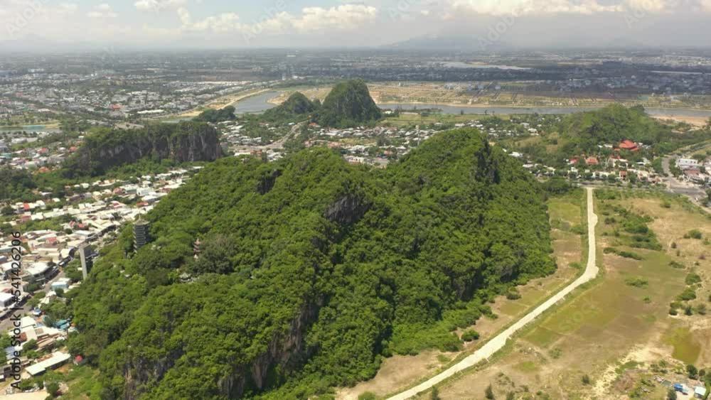 Aerial view of scenic Marble Mountains with Temple Tower, caves, beach, cliffs and Buddha statue in Danang, Central Vietnam. Aerial view of scenic Marble Mountains with Temple Tower, caves, beach, cliffs and Buddha statue in Danang, Central Vietnam.