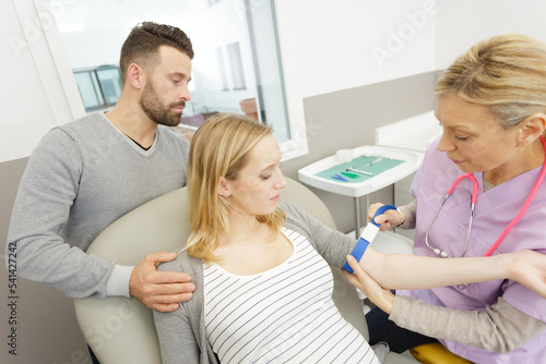 pregnant woman getting her pulse checked