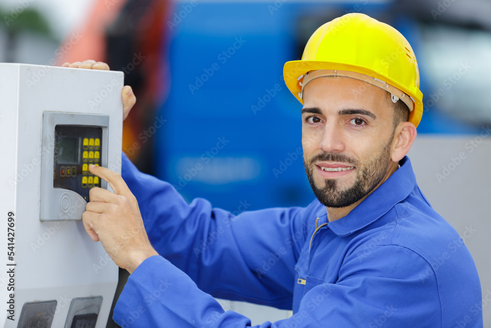 using the machine and pressing on buttons in the factory using the machine and pressing on buttons in the factory