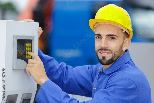 using the machine and pressing on buttons in the factory