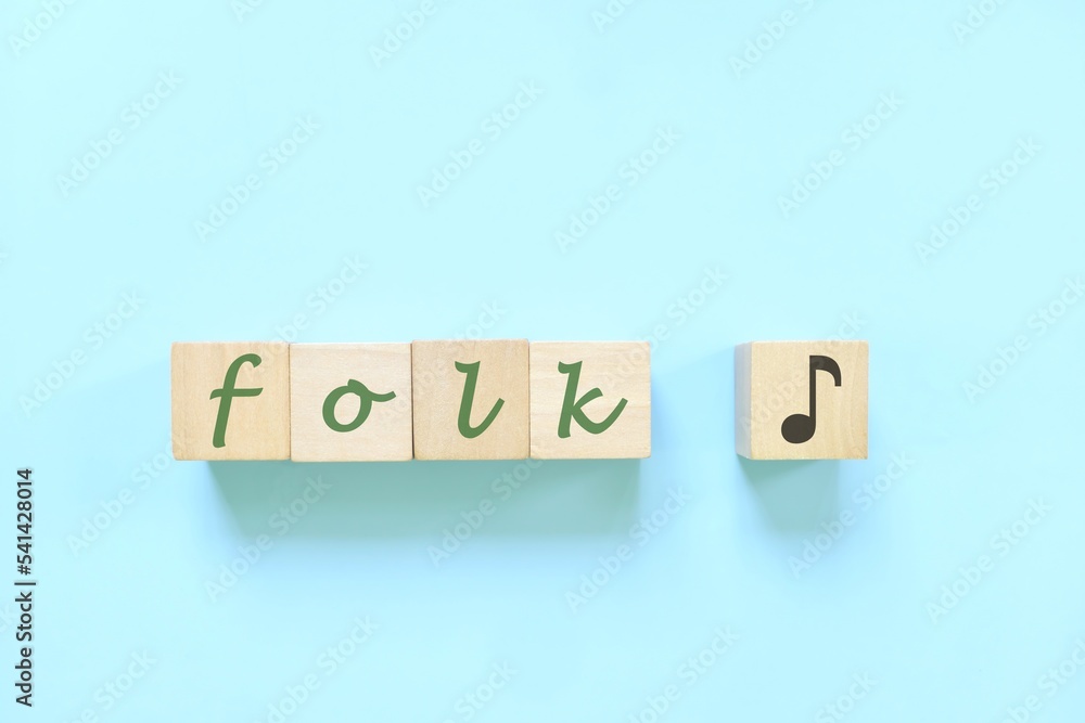 Folk music genre or style concept. Creative flat lay typography composition in blue background. Folk music genre or style concept. Creative flat lay typography composition in blue background.