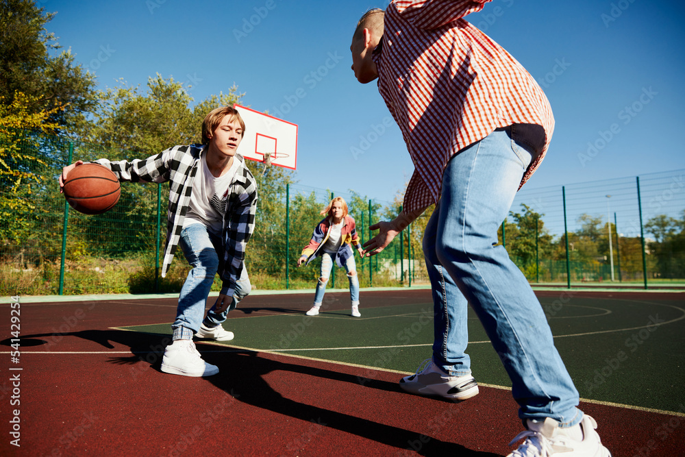 Young boys and girls, students bonding outdoors to play street basketball.  Teens wearing casual style clothes. Youth, sport, energy, motion, active  lifestyle Photos | Adobe Stock