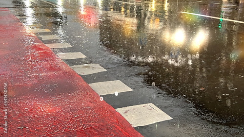  wet asphalt  road markings for cyclists  under rain evening light blurr on road termplate background defocus  photo