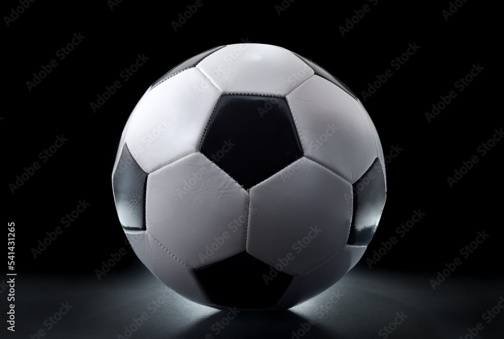 View of football ball isolated on table and black background