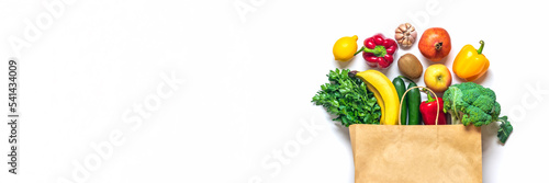 Eco friendly paper shop bag with raw organic green vegetables isolated on white background Flat lay, top view Zero waste, plastic free concept Healthy clean eating diet and detox, agriculture concept