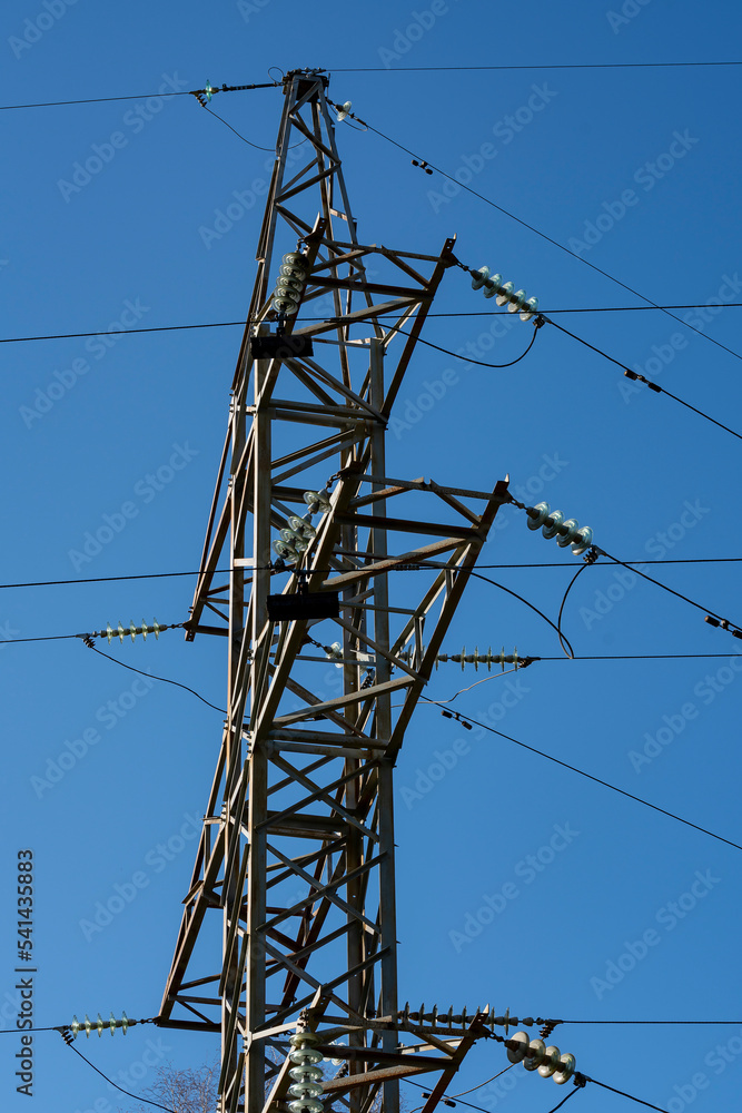 Metal electric tower with wires against the blue sky. Power supply. Metal electric tower with wires against the blue sky. Power supply.
