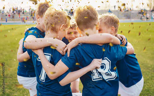 Male school soccer team celebrating success