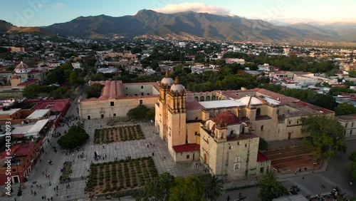 orbital drone shot of santo domingo temple in downtown oaxaca city in mexico during sunset photo