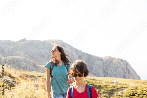 mother with a child on a hike walk along the road