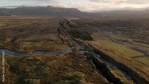 Thingvellir National Park with Oxararfoss Waterfall in Iceland. Aerial forward tilt down photo