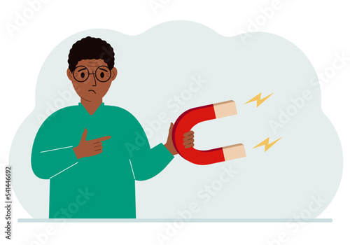 A man holds a huge magnet in his hand, attracts new customers, money and ideas. Inbound business marketing technologies, lead generation concept.