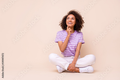 Full size photo of young adorable gorgeous nice woman sitting dreamy about new boyfriend look empty space isolated on beige color background