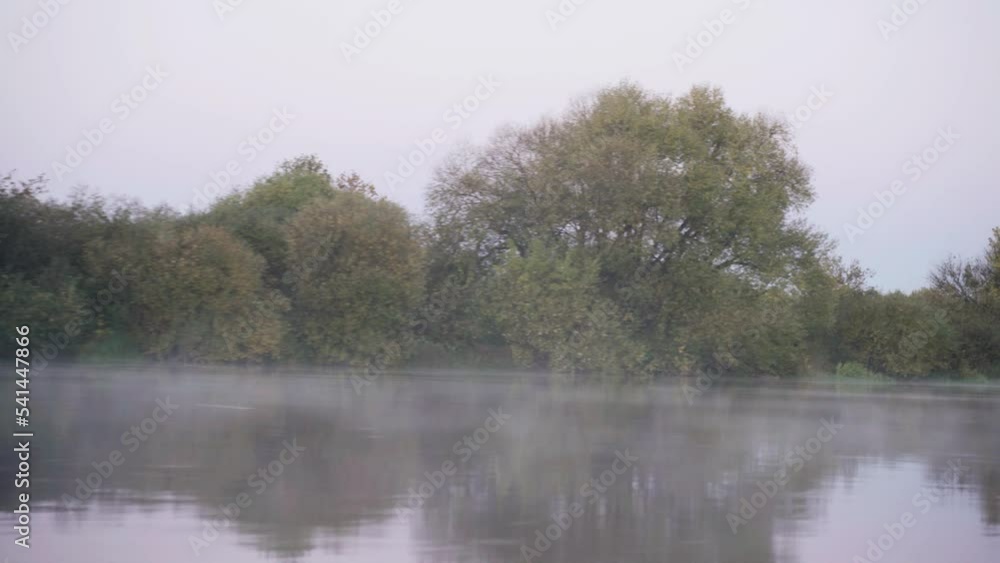 Vacation and hobby concept. Video filming from a motor boat during the movement of the river bank in the fog, ducks taking off. Vacation and hobby concept. Video filming from a motor boat during the movement of the river bank in the fog, ducks taking off.