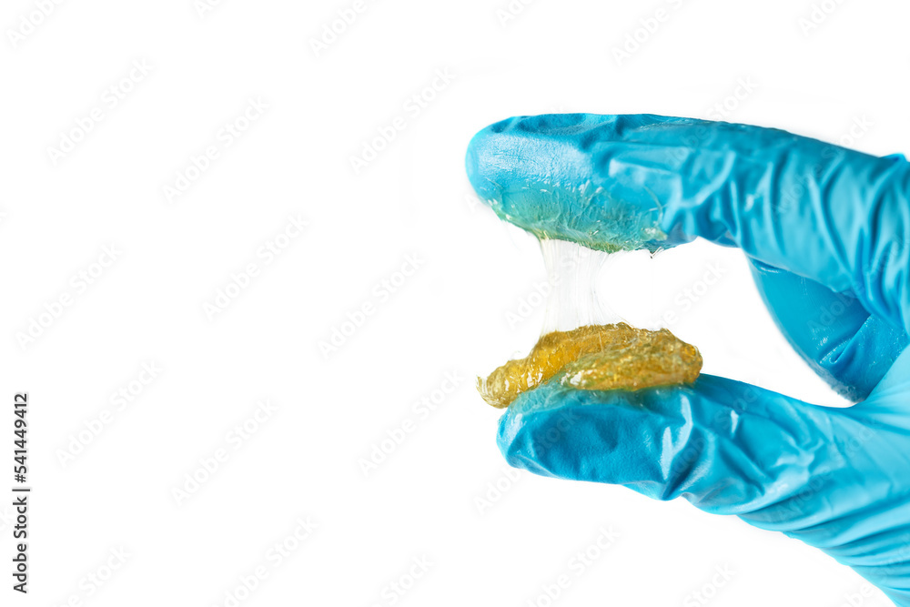 Worker use two finger and squeeze lithium grease and see the fiber of