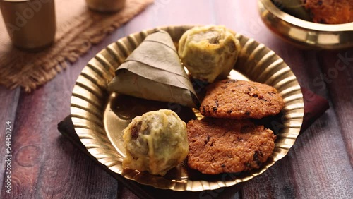 Sukhiyan or Sugiyan Parippu Vada Ila Ada Sweet rice dumplings Elayada steamed rice cakes wrapped in banana leaves famous breakfast or tea snacks of Kerala India. photo