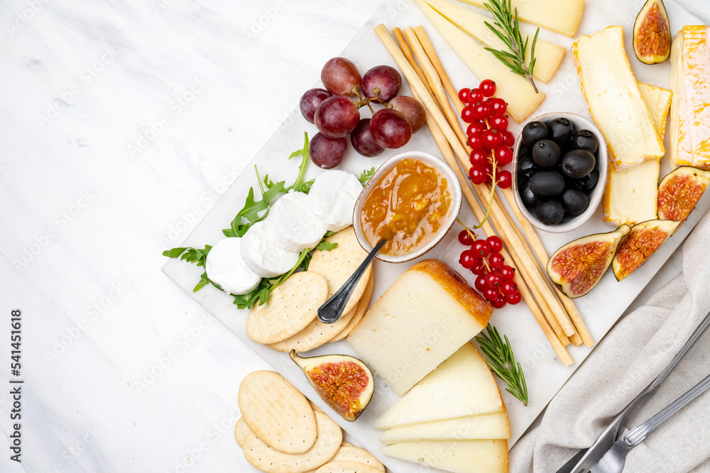 Сheese plate with gorgonzola parmesan brie or camembert and maasdam. served with berries and crackers. 