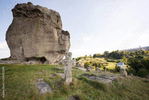 Pidkamin inselberg stone on hill and ancient graveyard. Ukraine.