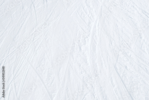 Top view of white ski tracks pattern on snow background.